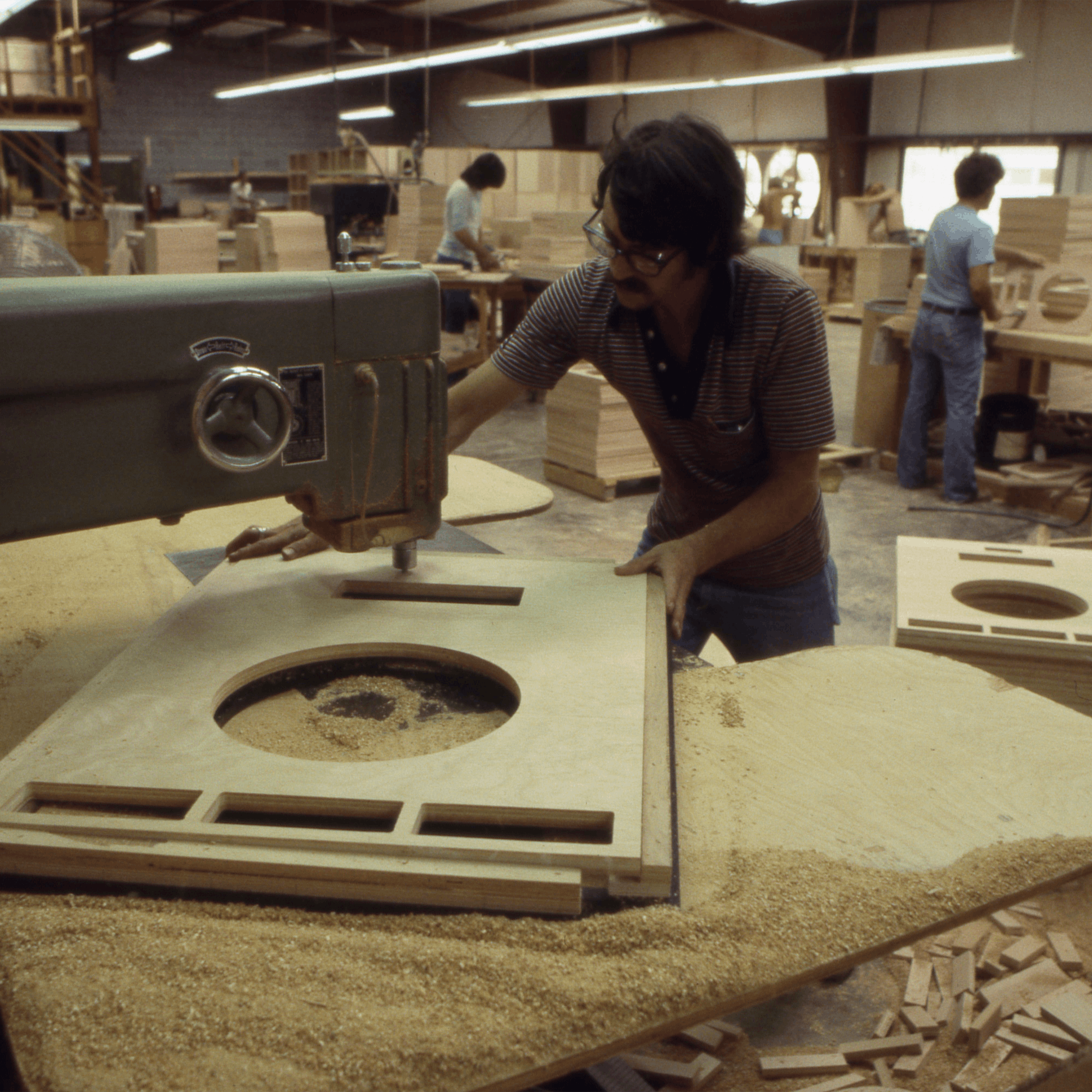 A Klipsch Craftsman handcrafting part of a Cornwall II speaker cabinet